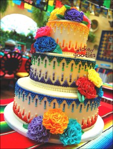 Mexican themed round wedding cake with modeling chocolate carnations and piped buttercream frosting cascading dot design in many colors by Wicked Goodies